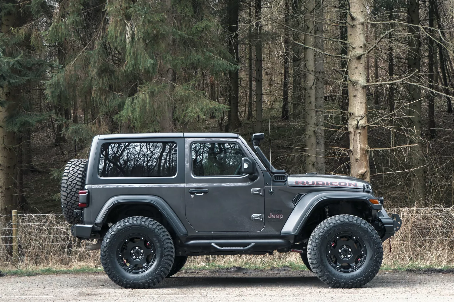 A relevant stock photo of 2 door jeep wrangler custom in a typical setting.