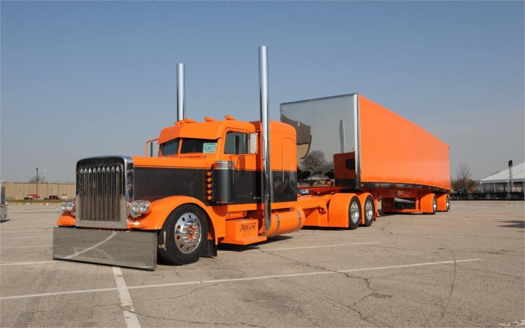 A relevant stock photo of peterbilt trucks custom in a typical setting.