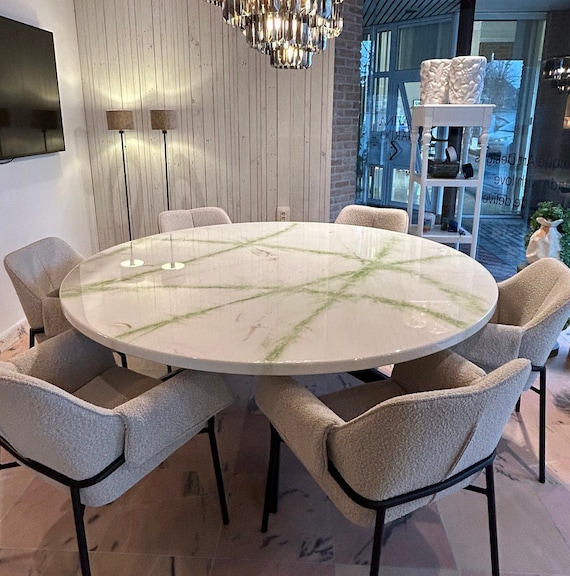 A relevant stock photo of round dining table custom in a typical setting.